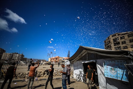 Leaflets, prepared by Israeli forces to warn civilians in Gaza City to move to the southern part of the Gaza Strip, are dropped from the air as part of Israel's ground operation in Gaza.