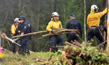 NSW police officers and Rural Fire Service volunteers search bushland on the mid-north coast