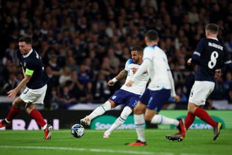 Kyle Walker of England shoots and Phil Foden, in the foreground, turns it home.