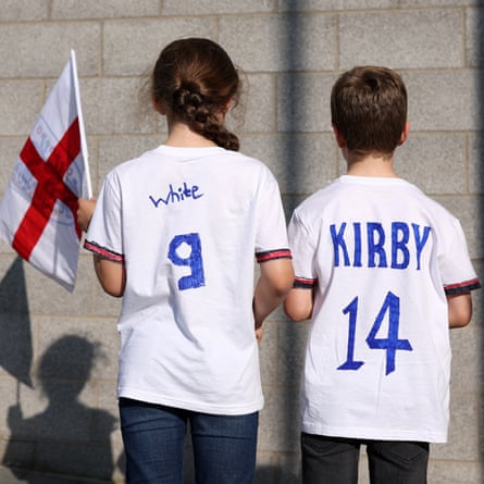 England fans wearing shirts with the names of Ellen White and Fran Kirby look on outside the stadium.