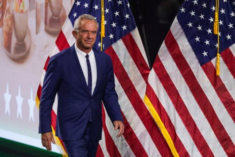 Robert F Kennedy Jr walks past US flags