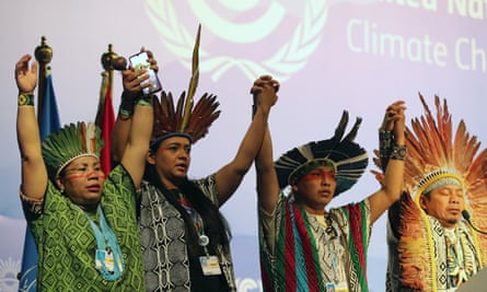 The president of the Federation of the Huni Kui People in Acre, Brazil, Ninawa Inu Huni kui Pereira Nunes (R) and other members representing indigenous communities, peform a ritual prayer.