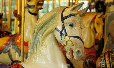 Close up of white merry-go-round horses