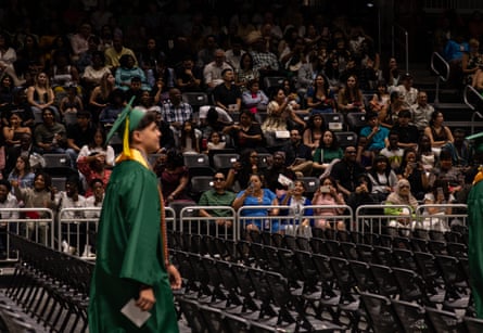 a young man walking as people take photos of him