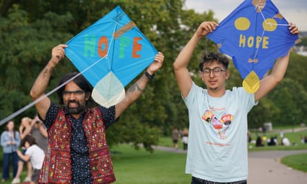 Two men with kites that read “Hope”.
