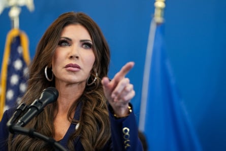 Kristi Noem at lectern, pointing.