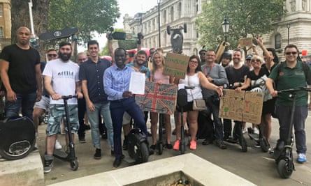 Demonstrators outside Downing Street calling for the legalisation of e-scooters on UK roads.