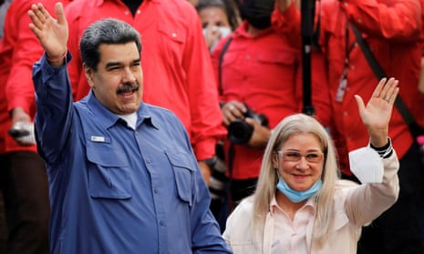 President Nicolas Maduro and his wife Cilia Flores wave at a Venezuelan government rally in February