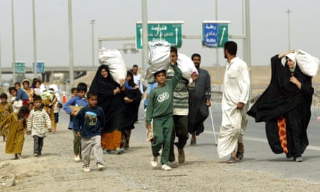Iraqis leaving Fallujah after a car exploded at a checkpoint in the city, Iraq, 29 April 2004.