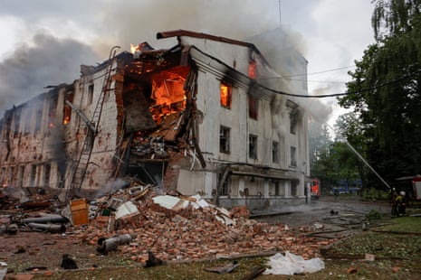 Firefighters work at the site of a building hit by a Russian drone strike in Kharkiv, Ukraine, on Saturday.