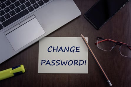 A change password sign next to a laptop.