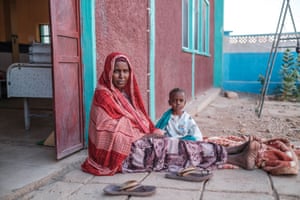 Dhool Ali Duale (L), sits next to her son, Abdullahi Higad Ali (R), 5, outside the nutrition unit at Gode general hospital