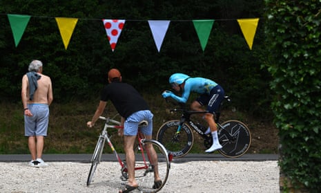 A fan on a bike watches Cees Bol go past.