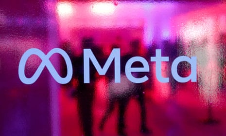 People walk behind a Meta Platforms logo during a conference in Mumbai, India, September 20, 2023. 
