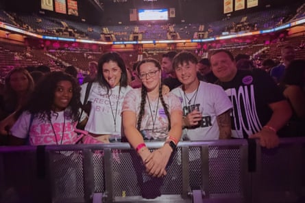 fans stand at the barricade in an arena