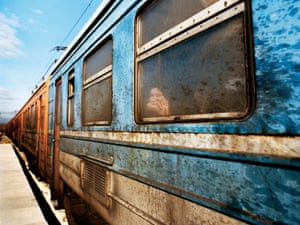 A refugee peers from a train in Macedonia.