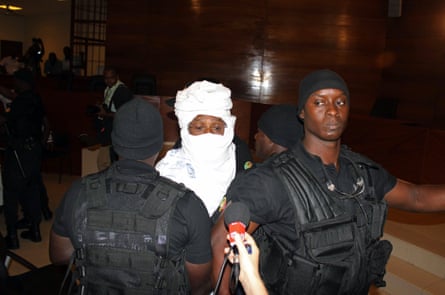 Security guards surround the former Chadian dictator Hissène Habré on his first appearance at the special international court in Senegal’s capital Dakar.