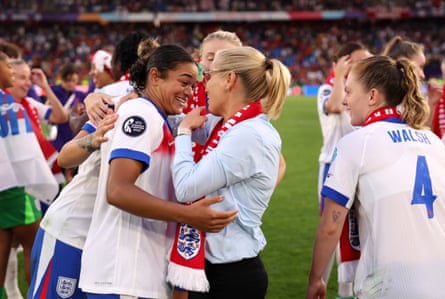 Jess Carter is embraced by Sarina Wiegman and teammates after victory in the Euro 2025 final match between England and Spain