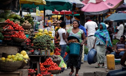Women sell vegetables and other food in a market in Lagos, Nigeria.