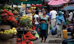Women sell vegetables in a market in Lagos, Nigeria