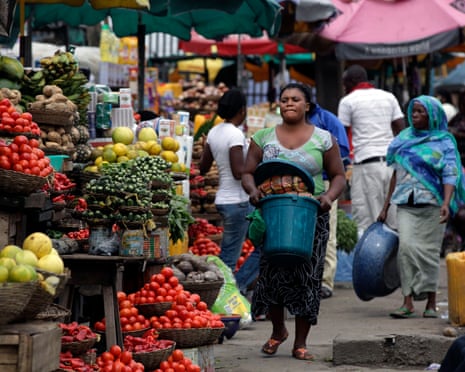 Women sell vegetables in a market in Lagos, Nigeria