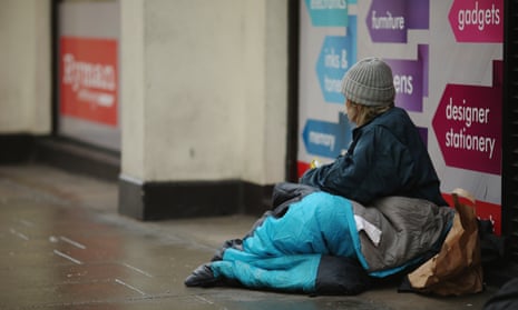 homeless woman in shop doorway