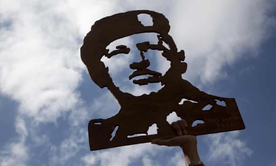 An image of Venezuela’s late president Hugo Chávez is raised aloft by supporters of president Nicolás Maduro.