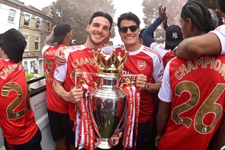 Declan Rice beams alongside Arsenal teammate Christian Nørgaard during Arsenal’s Premier League trophy parade successful May