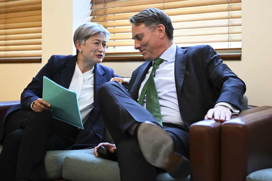 Deputy prime minister Richard Marles speaks to foreign minister Penny Wong during Labor party caucus at Parliament House in Canberra yesterday.