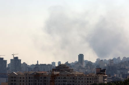 Tehran’s city skyline with smoke in the sky