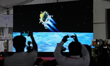 People in mission control in Bengaluru watch the landing