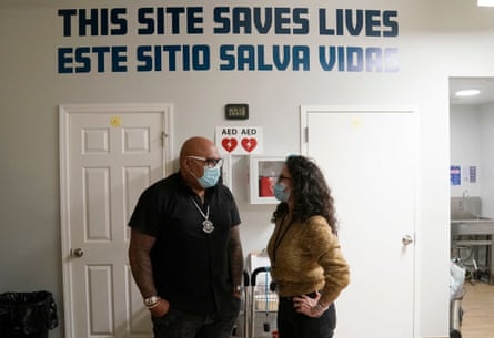 sign in background says ‘this site saves lives’