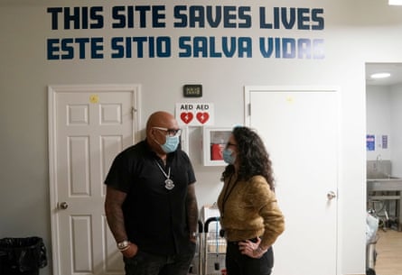 the sign in the background says 'this site saves lives'
