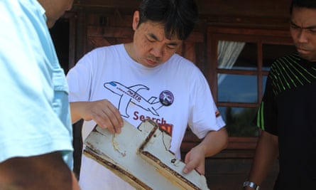 Jiang Hui examines some suspected debris from the plane that was found in Madagascar last year.