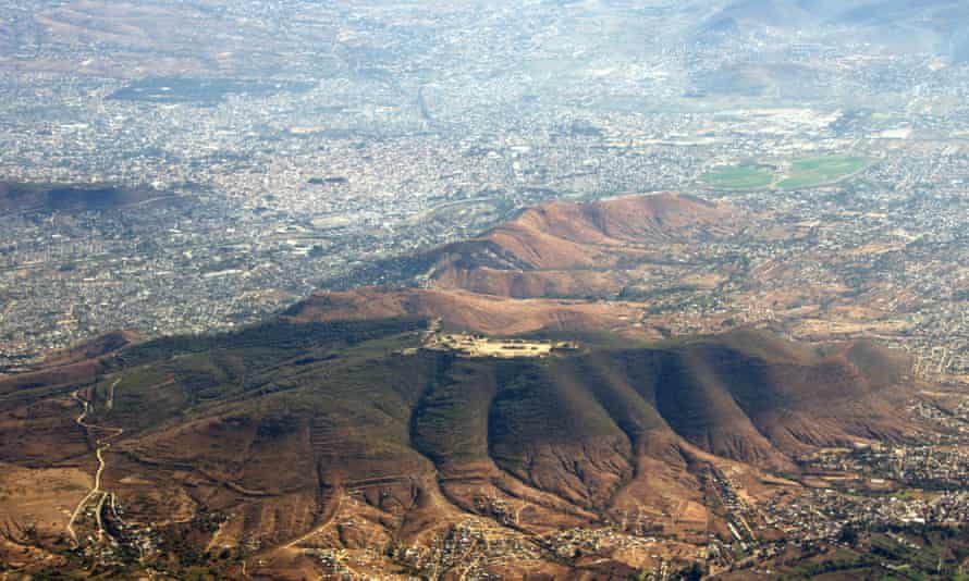 Aerial view of the ruins of Monte Albán (on top of the hill) with the city Oaxaca de Juarez spreading around them.
