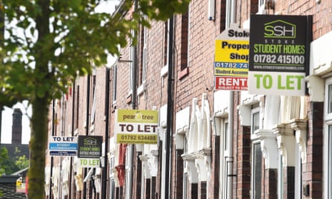 Various property signs are seen outside a block of terraced houses advertising homes for sale, let or sold