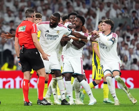 Real MadridâÂÂs VinÃÂcius Júnior is held back by Antonio Rüdiger after being sent off
