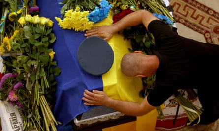 A soldier at the funeral of Ukrainian fighter pilot Andriy Pilshchykov in Kyiv, Ukraine, 29 August 2023