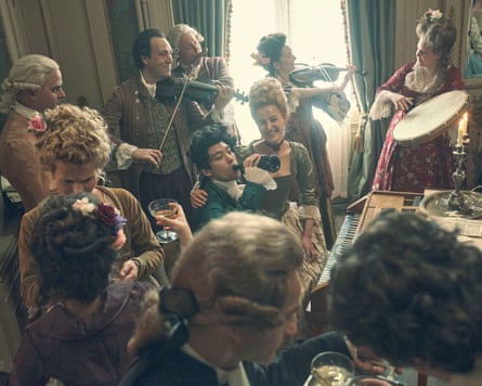 Will Sharpe in the centre of a group as Wolfgang Amadeus Mozart