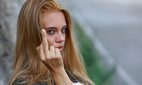 Rude,Vindictive,Young,Woman,Giving,The,Middle,Finger,In,AnRude vindictive young woman giving the middle finger in an obscene gesture with focus to her hand in a close up head shot; Shutterstock ID 2013953027; purchase_order: -; job: -; client: -; other: -