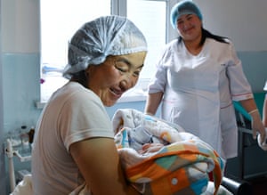 Dr Baktygul Pakirova watches Jiydegul hold her newborn son, Nurdan. After two days in hospital, mother and son will be ready to go home