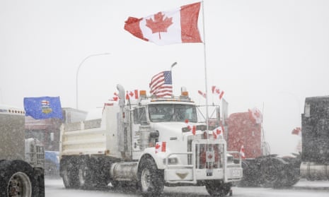 Anti-Covid-19 vaccine mandate demonstrators gather as a truck convoy blocks the highway at the busy US border crossing in Coutts, Alberta, this week.