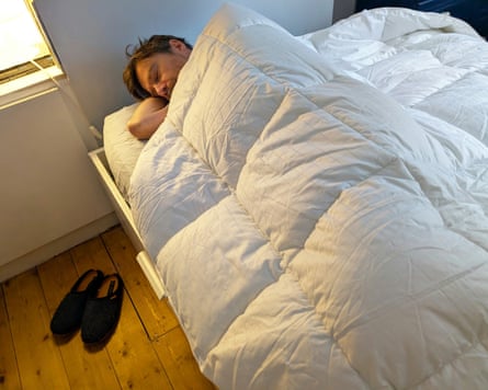 A man wrapped in the Soak & Sleep Soft as Down duvet.