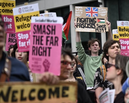 Protesters with placards reading ‘Refugees welcome’, ‘smash the far right’ and ‘fighting fascists since 1939’