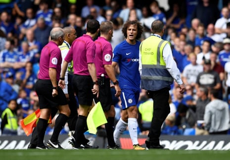 David Luiz remonstrates with referee Craig Pawson as he walks off at half-time.