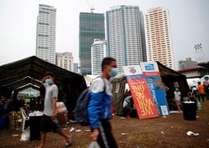 Stranded Filipino villagers with their belongings take shelter in military tents during the coronavirus pandemic in Manila, Philippines,on 29 July 2020. Most work as domestic servants, babysitters, construction workers, shippers, or sailors, but now face a bleak future having lost their job because of the pandemic.