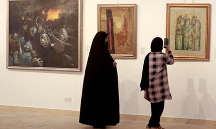 Visitors look at paintings by the famous artist Faiq Hassan.