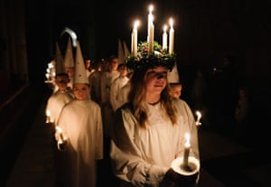 Matilda Jarl, 15, from Jarfalla, Sweden leads the procession during the Sankta Lucia Festival of Light at York Minster