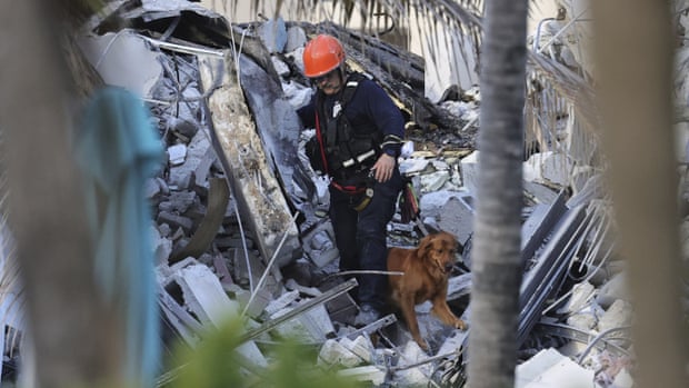 Fire rescue personnel conduct a search and rescue with dogs through the rubble of the Champlain Towers South condo. Miami building collapse: one dead as rescue crews say 99 unaccounted for,123news
