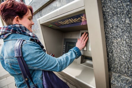 A young woman female college university student withdrawing money from ATM